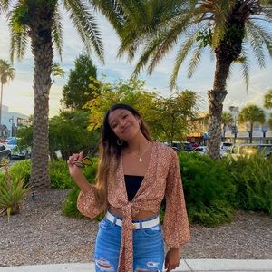 This is a beautiful sheer cover top that can be worn over a white or black top!